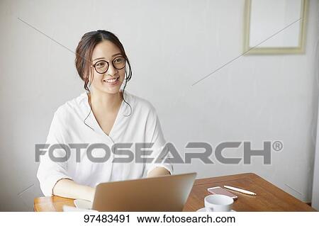 Japanese woman working at a cafe View Large Photo Image Stock Image - Japanese woman working at a cafe. Fotosearch