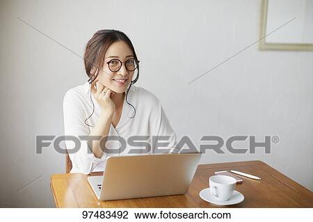 Japanese woman working at a cafe View Large Photo Image Stock Image - Japanese woman working at a cafe. Fotosearch