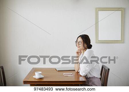 Japanese woman working at a cafe View Large Photo Image Stock Image - Japanese woman working at a cafe. Fotosearch
