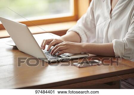 Japanese woman working at a cafe View Large Photo Image Stock Image - Japanese woman working at a cafe. Fotosearch