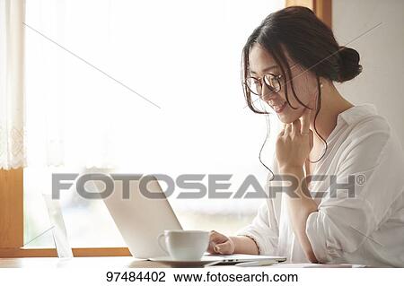Japanese woman working at a cafe View Large Photo Image Stock Image - Japanese woman working at a cafe. Fotosearch