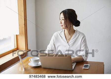 Japanese woman working at a cafe View Large Photo Image Stock Photo - Japanese woman working at a cafe. Fotosearch