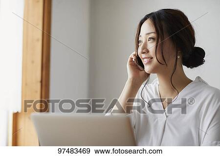 Japanese woman working at a cafe View Large Photo Image Stock Photo - Japanese woman working at a cafe. Fotosearch