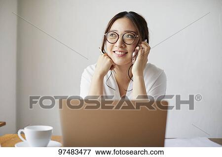 Japanese woman working at a cafe View Large Photo Image Stock Photo - Japanese woman working at a cafe. Fotosearch