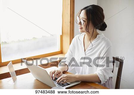 Japanese woman working at a cafe View Large Photo Image Stock Photo - Japanese woman working at a cafe. Fotosearch