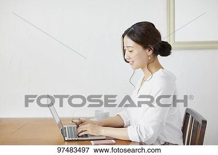 Japanese woman working at a cafe View Large Photo Image Stock Photo - Japanese woman working at a cafe. Fotosearch