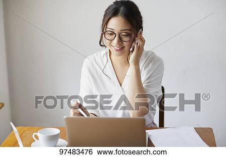 Japanese woman working at a cafe View Large Photo Image Stock Photograph - Japanese woman working at a cafe. Fotosearch