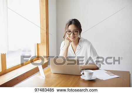 Japanese woman working at a cafe View Large Photo Image Stock Photography - Japanese woman working at a cafe. Fotosearch