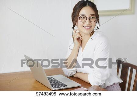 Japanese woman working at a cafe View Large Photo Image Stock Photography - Japanese woman working at a cafe. Fotosearch