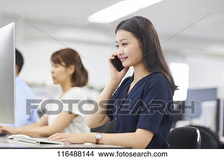 Japanese woman working in the office View Large Photo Image Picture - Japanese woman working in the office. Fotosearch