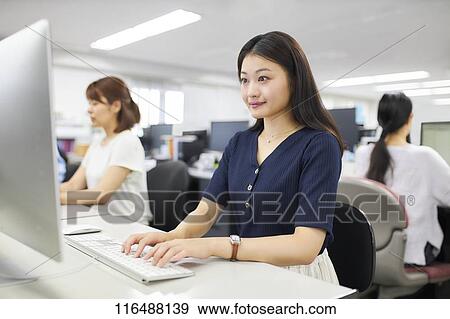 Japanese woman working in the office View Large Photo Image Stock Photo - Japanese woman working in the office. Fotosearch