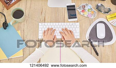 Stock Image - Japanese woman working remotely. Fotosearch