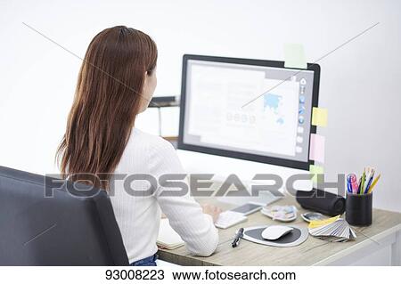 Stock Image - Japanese woman working remotely. Fotosearch