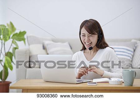 Japanese woman working remotely View Large Photo Image Stock Image - Japanese woman working remotely. Fotosearch