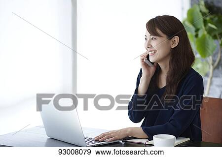 Japanese woman working remotely View Large Photo Image Stock Photo - Japanese woman working remotely. Fotosearch
