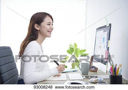 Japanese woman working remotely View Large Photo Image Stock Photo - Japanese woman working remotely. Fotosearch