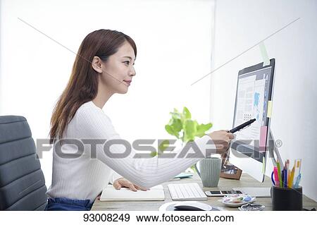 Japanese woman working remotely View Large Photo Image Stock Photo - Japanese woman working remotely. Fotosearch