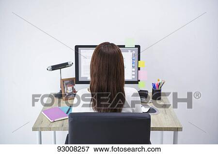Stock Photo - Japanese woman working remotely. Fotosearch