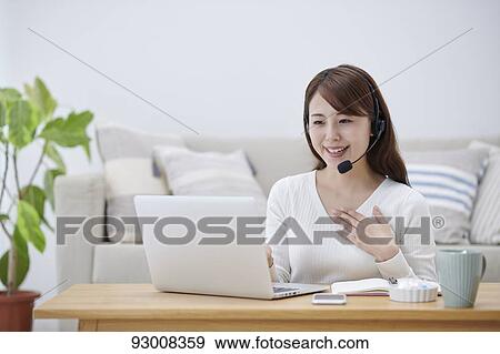 Japanese woman working remotely View Large Photo Image Stock Photo - Japanese woman working remotely. Fotosearch