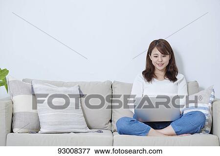 Japanese woman working remotely View Large Photo Image Stock Photo - Japanese woman working remotely. Fotosearch