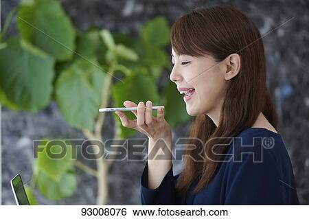 Stock Photograph - Japanese woman working remotely. Fotosearch