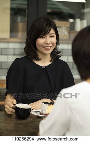 Picture - Japanese women at a cafe. Fotosearch