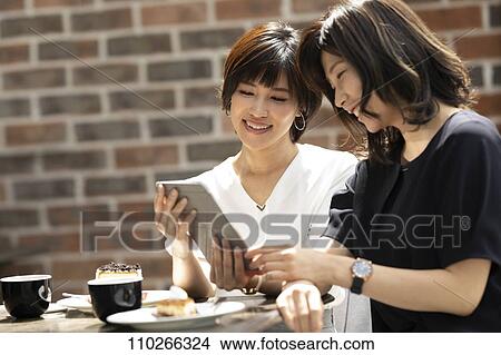 Picture - Japanese women at a cafe. Fotosearch