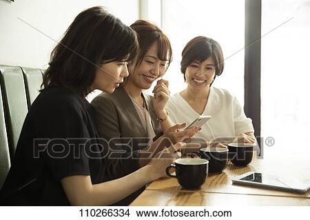 Picture - Japanese women at a cafe. Fotosearch