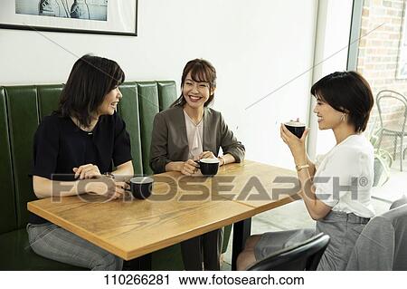 Stock Image - Japanese women at a cafe. Fotosearch