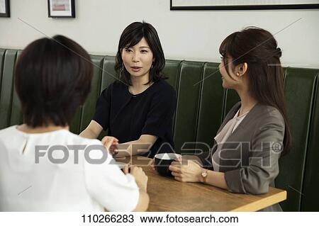 Stock Image - Japanese women at a cafe. Fotosearch