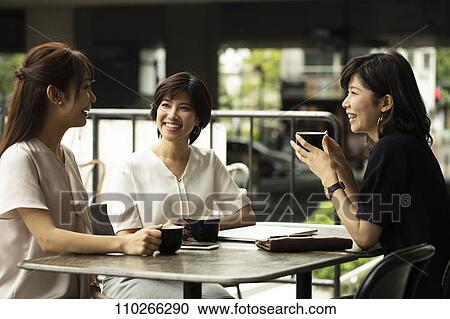 Stock Image - Japanese women at a cafe. Fotosearch