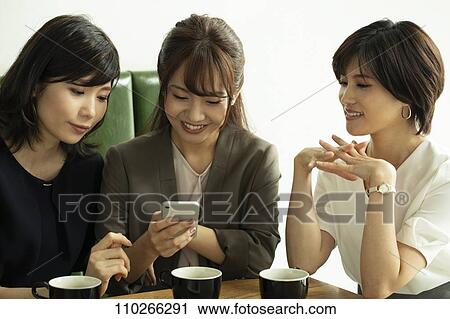 Stock Image - Japanese women at a cafe. Fotosearch