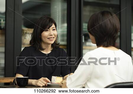 Stock Image - Japanese women at a cafe. Fotosearch