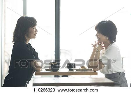Stock Image - Japanese women at a cafe. Fotosearch