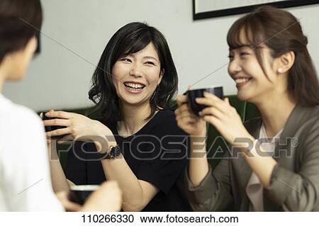 Stock Image - Japanese women at a cafe. Fotosearch