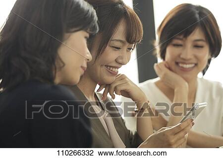 Stock Image - Japanese women at a cafe. Fotosearch