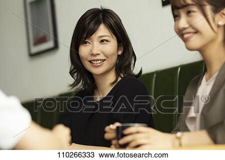 Stock Image - Japanese women at a cafe. Fotosearch