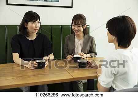 Stock Photograph - Japanese women at a cafe. Fotosearch