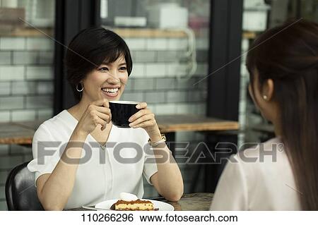 Stock Photograph - Japanese women at a cafe. Fotosearch