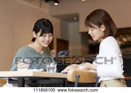 Japanese women at a restaurant View Large Photo Image Stock Image - Japanese women at a restaurant. Fotosearch