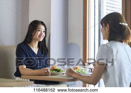 Stock Image - Japanese women at a restaurant. Fotosearch