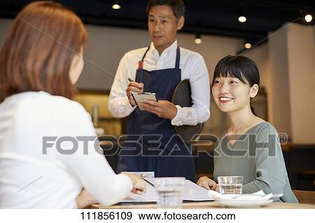 Japanese women at a restaurant View Large Photo Image Stock Photo - Japanese women at a restaurant. Fotosearch