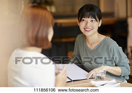 Stock Photograph - Japanese women at a restaurant. Fotosearch