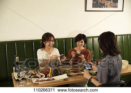 Japanese women happily dining together View Large Photo Image Stock Image - Japanese women happily dining together. Fotosearch
