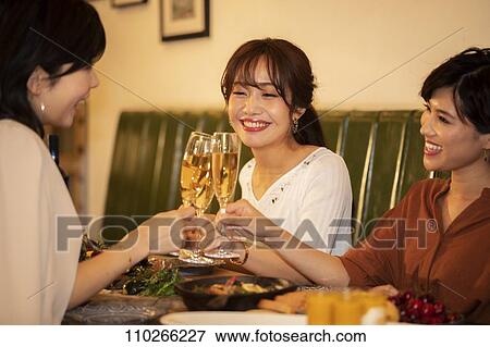 Stock Photo - Japanese women happily dining together. Fotosearch