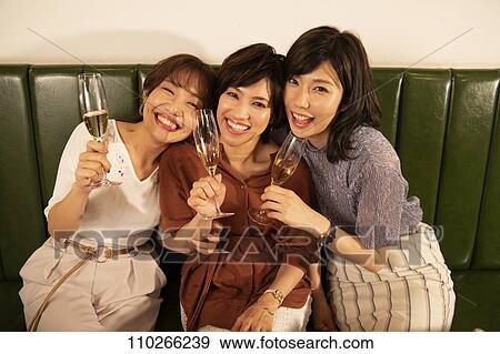 Stock Photo - Japanese women happily dining together. Fotosearch