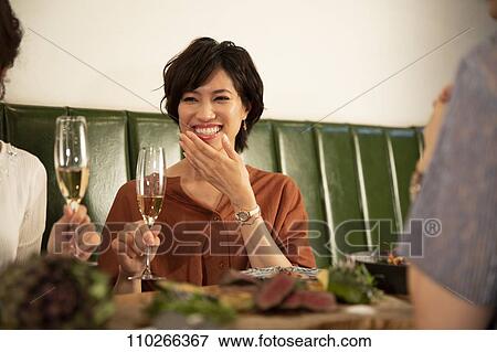Stock Photo - Japanese women happily dining together. Fotosearch