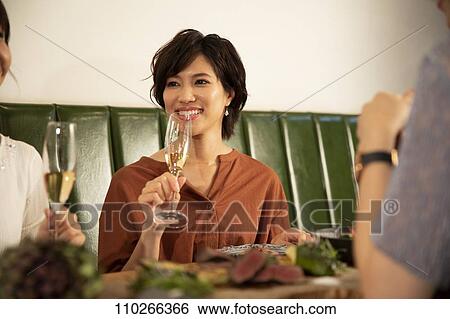 Stock Photograph - Japanese women happily dining together. Fotosearch