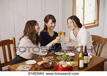 Picture - Japanese women having home party. Fotosearch