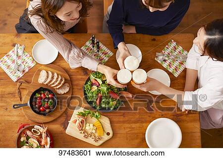Stock Image - Japanese women having home party. Fotosearch